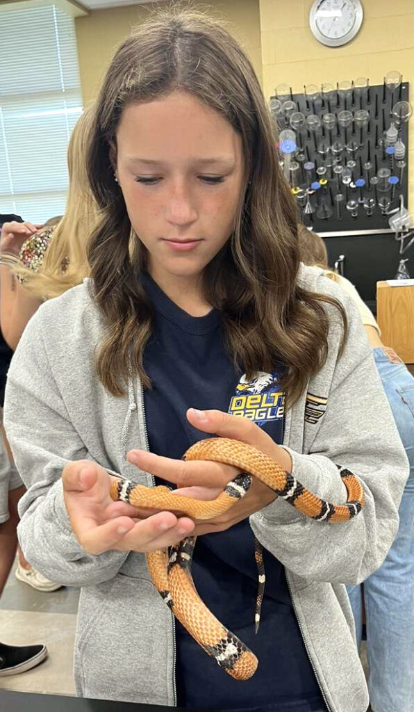 Girl holding snake