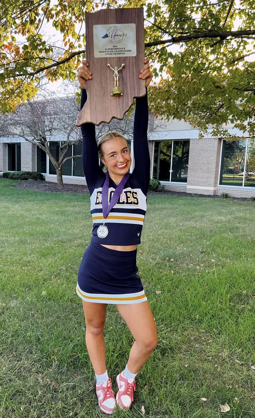 Cheerleader with trophy